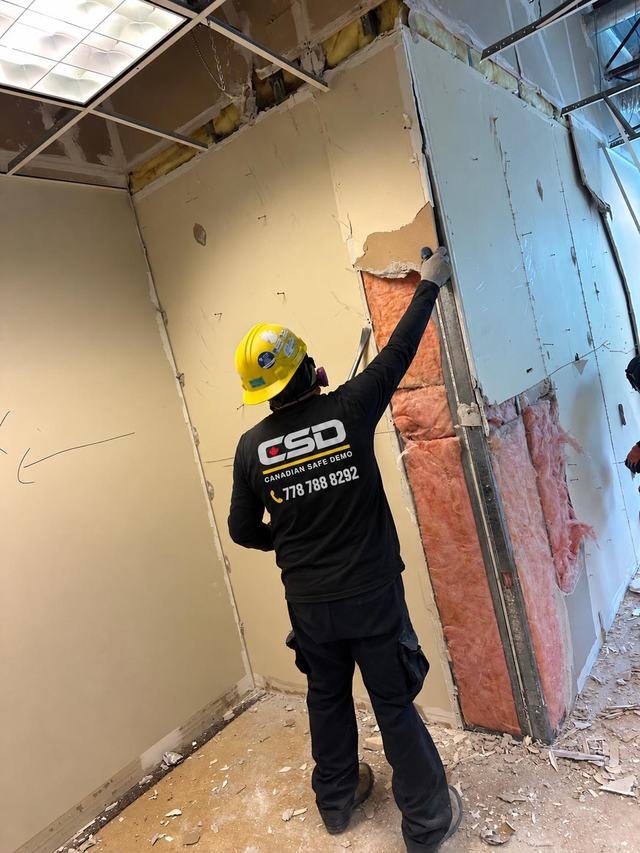 Drywall removed to expose insulation and steel studs